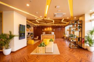 eine Bürolobby mit gelben Möbeln und Pflanzen in der Unterkunft Bloom Hub - ORR Marathahalli in Bangalore