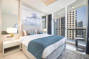 a bedroom with a large bed and a large window at Magnificent - Damac Distinction Downtown in Dubai