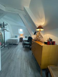 Zimmer mit einem Bett und einem Schreibtisch mit einer Lampe in der Unterkunft Les rêves d'Angèle in Crain