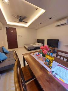 a living room with a table and a couch at Rest And Go Homestay in Shah Alam