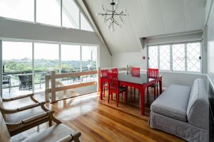 a living room with a table and chairs and a couch at Jacobs Hill Tagaytay in Tagaytay