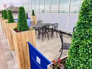 a patio with a table and chairs and plants at Grand Hotel Sunderland in Sunderland