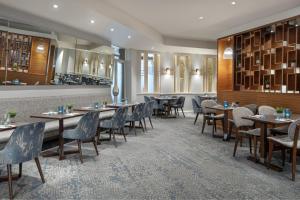 a restaurant with tables and chairs and a bar at Delta Hotels by Marriott Peterborough in Peterborough