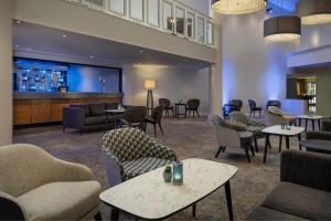 a lobby with tables and chairs and a bar at Delta Hotels by Marriott Peterborough in Peterborough