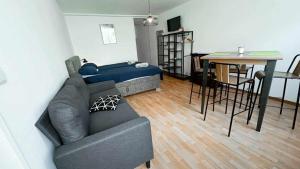 a living room with a couch and a table at Studio entier in Porrentruy