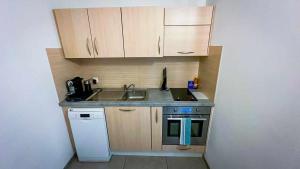 a small kitchen with a sink and a stove at Studio entier in Porrentruy