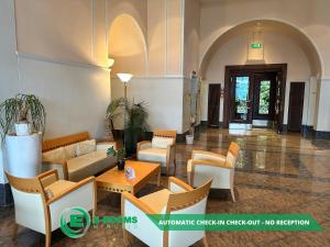 a lobby of a building with couches and chairs at E-Rooms Minusio in Locarno