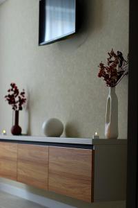 a counter with two vases and flowers on it at Candle Space in Chişinău