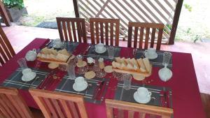 a table with food and tea pots and bread at Les Citronniers in Sainte Marie