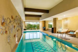 a swimming pool in a hotel room with a living room at Karma Chalets in Gurgaon