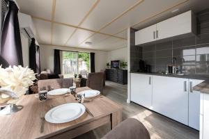 a kitchen and dining room with a wooden table and chairs at 16, Geniet van de rust, natuur & gratis parkeren! in Oisterwijk