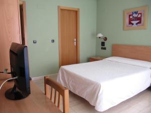 Postel nebo postele na pokoji v ubytování Hostal Meseguer