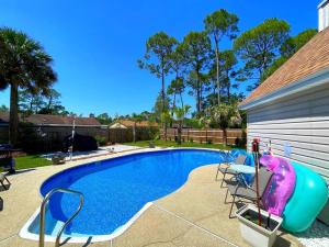 a large swimming pool with a inflatable at Very Private 3 Bed Home with HEATED Pool Palms and Big Fenced Yard in Pensacola