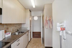 a small kitchen with a sink and a refrigerator at Affordable Comfort in Zurich in Zürich