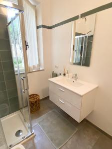 a bathroom with a sink and a shower at Alloggio 2 / Casa Marley Porto Pollo in Barrabisa +26 photos