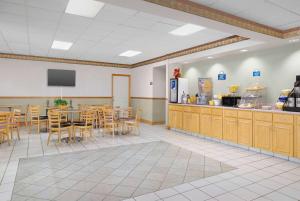 a dining room with a table and a kitchen at Days Inn by Wyndham Lake City I-75 in Lake City