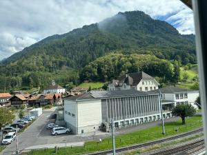 a town with a train station and a mountain at HOTEL CHRISTINA in Wilderswil