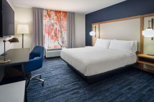 a hotel room with a bed and a desk at Fairfield Inn & Suites Auburn Opelika in Opelika