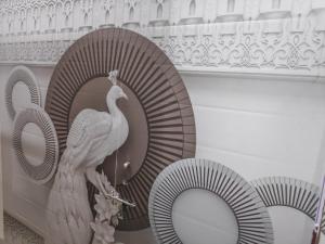 a sculpture of a peacock on a wall at Vrindavan Nivas -Near Prem mandir bankey bihari in Vrindāvan