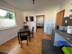 a kitchen and dining room with a table and chairs at Fe Wo Steffen in Alsfeld