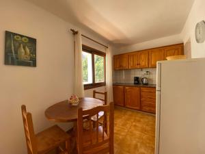 a kitchen with a wooden table and a refrigerator at Apartamento Nelly A3 in Valle Gran Rey