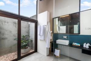 a bathroom with a sink and a mirror at Inidi Leisure Luxury Villas in Wadduwa