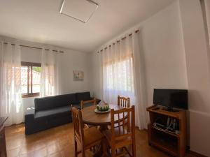 a living room with a couch and a table with chairs at Apartamento Nelly A2 in Valle Gran Rey