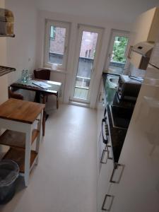 a small kitchen with a counter and a table at Excellent Hotel Hamburg in Hamburg