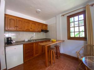 a kitchen with wooden cabinets and a counter top at Apartamento Nelly S2 in Valle Gran Rey