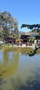 a large body of water with a building in the background at Casa Lumiar in Lumiar