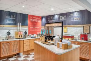 a fast food restaurant with a counter with food at Hampton Inn Baltimore/White Marsh in White Marsh