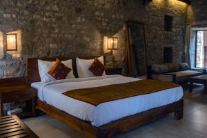 a bedroom with a large bed in a room at Wada1 in Aihole