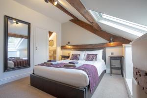 a bedroom with a large bed and a window at Goody Bridge Barn in Grasmere