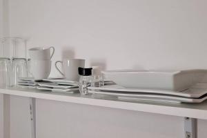 a table with plates and cups and glasses on it at Villa Blanca, W-Lan, Office in Leverkusen