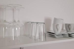 a row of clear wine glasses sitting on a counter at Villa Blanca, W-Lan, Office in Leverkusen