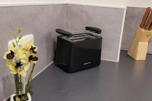 a black printer sitting on a counter with flowers in a vase at Villa Blanca, W-Lan, Office in Leverkusen