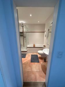 ein Badezimmer mit einer Badewanne, einem WC und einem Waschbecken in der Unterkunft Minimalharmony Apartment in Hannover