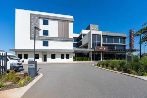 a parking lot in front of a building at Ingot Hotel Perth, Ascend Hotel Collection in Perth