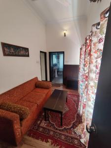 a living room with a couch and a table at The Fateh Hotel by Le Pension Stays in Udaipur