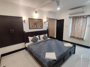 a bedroom with a bed with a blue comforter at The Fateh Hotel by Le Pension Stays in Udaipur +71 photos