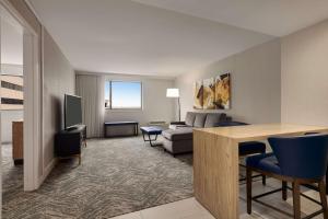 a living room with a couch and a table at DoubleTree by Hilton Canton Downtown in Canton