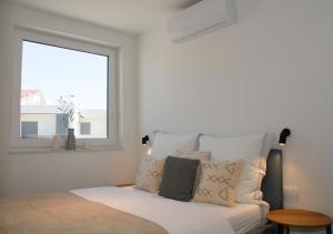 a bedroom with a bed with a window at Vodice For You - Holiday Homes in Vodice +61 photos