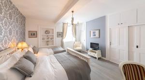 a bedroom with a white bed and a tv at The French Partridge, in Northampton