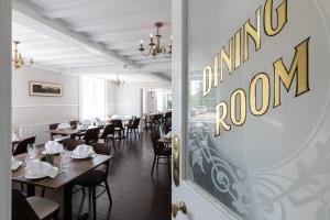 a restaurant with tables and chairs and a sign on the door at The French Partridge, in Northampton