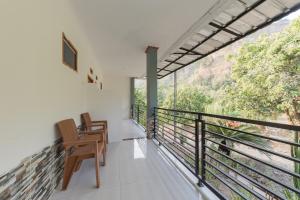 Habitación con balcón con sillas y vistas. en RedDoorz near Ciletuh Sukabumi, en Cilowa
