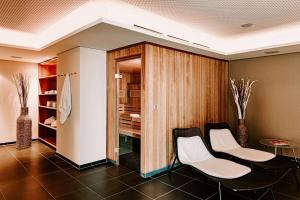 a dining room with two chairs and a closet at Vienna House Easy by Wyndham Stuttgart in Stuttgart