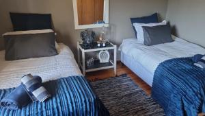 two beds sitting next to each other in a room at Angel 8 AirBnB Family Apartment in Robertson