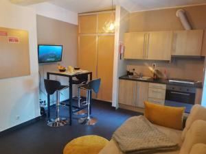 a kitchen and a living room with a table at Enjoy Lisboa! - Near Metro in Amadora