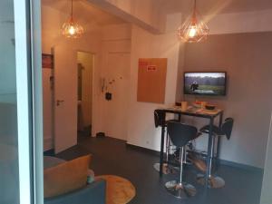 a living room with a table and a television at Enjoy Lisboa! - Near Metro in Amadora
