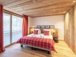 a bedroom with a bed and a large window at Chalet Courchevel, 6 pièces, 12 personnes - FR-1-568-36 in Courchevel